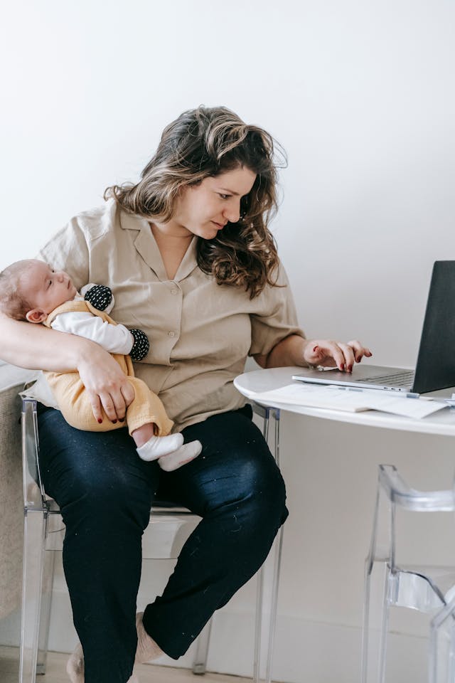 woman with baby working at computer